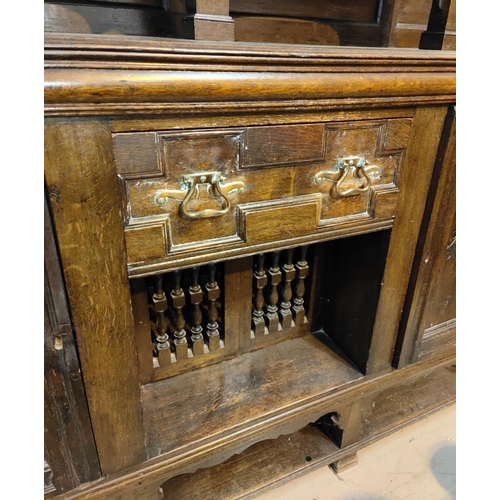 959 - A 19th century Jacobean style large dresser with raised panel back, 2 carved end cupboards, central ... 