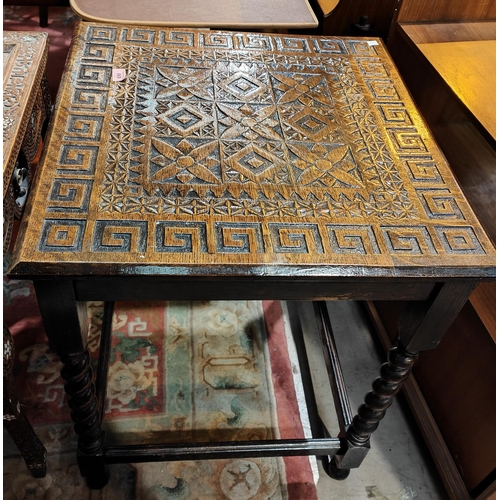 969 - An early 20th century oak occasional table with geometric carving to the square top, on barley twist... 