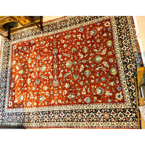 987 - A modern Persian hand knotted carpet with overall stylised floral decoration on rust ground, 350 x 2... 