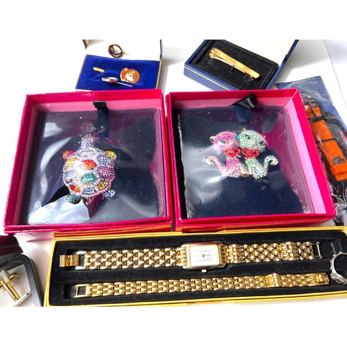 607 - A Swarovski Butler & Wilson brooch with multicoloured stones and a boxed Butler & Wilson bro... 