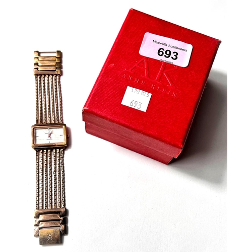 693 - A lady's dress watch by Anne Klein, in gilt metal with 5 strand woven strap and 'lifetime' batt... 