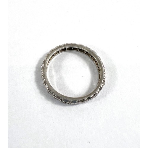 827 - A white metal eternity ring with diamonds in illusion settings, size L, gross 3.3gm