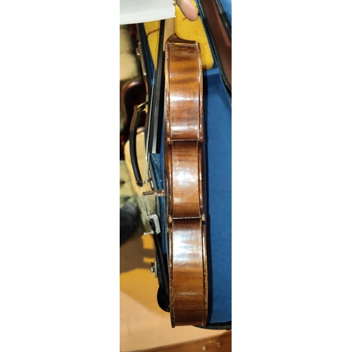 338 - A 20th century full size violin with two piece back, scrolling head, bow, fitted hard carry case