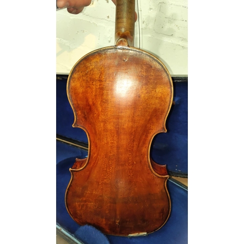 340 - A late 19th early 20th century full sized violin with two piece back wooden chin rest, in wooden fit... 