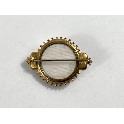 823 - A 19th century memorial target brooch set with a rose cut diamond, tested 15ct 10.2gms gross/6.4gms ... 