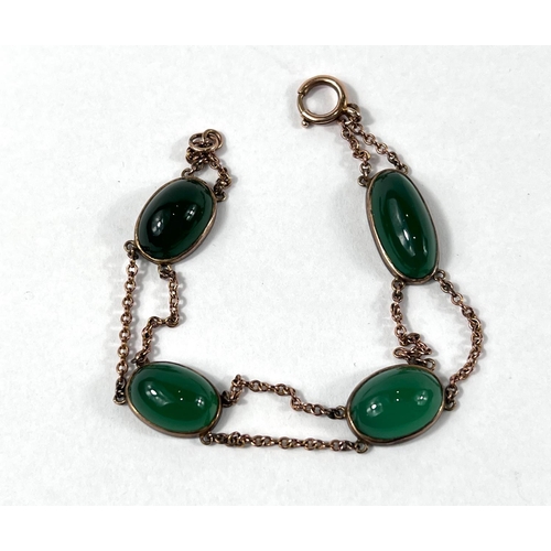 826 - A yellow metal bracelet set with 4 oval jade stones (tests at 9ct) 10.2gm gross