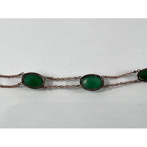 826 - A yellow metal bracelet set with 4 oval jade stones (tests at 9ct) 10.2gm gross