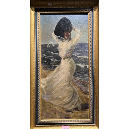 868 - W R Lavender:  Edwardian lady in white dress and hat on a windswept beach, oil on canvas, signed, 52... 