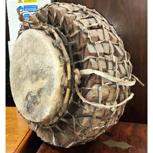 335A - An early to mid 20th century African style tribal drum with interlinking wooden sections, with hide ... 