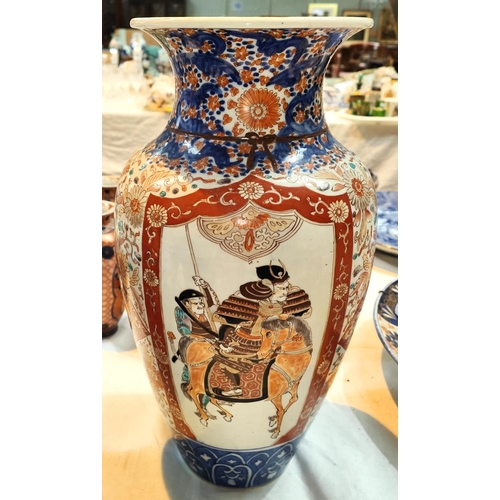 355 - A large Japanese Imari vase decorated with warriors on panels with a flared rim, height 45cm