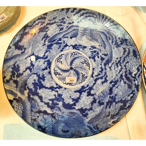 357 - A Chinese blue and white charger decorated with five clawed dragon circling mythical bird, 47cm