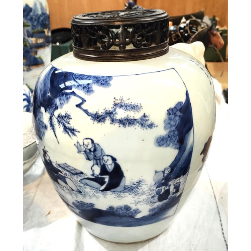 407A - A large blue & white ginger jar decorated with scenes of scholars, a pierced wood lid, on a hard... 