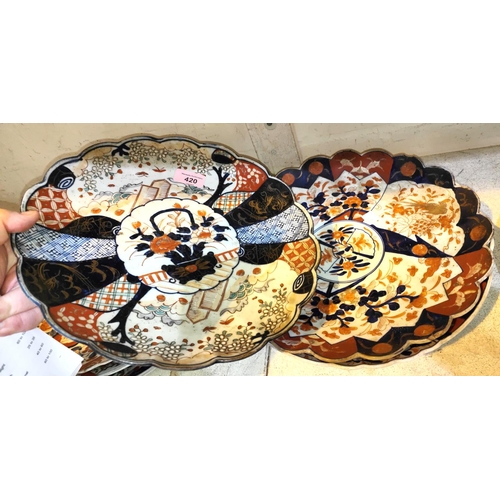 420 - Three Japanese Imari chargers with shaped edges, traditional and floral decoration, diameters 31cms ... 