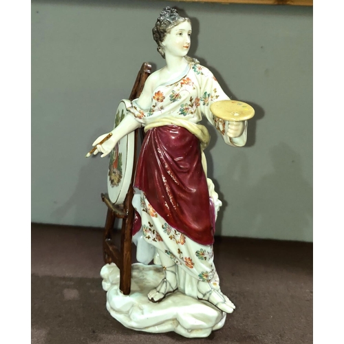 525 - A porcelain figure of a female painting at an easel in the Meissen style with crossed swords to base... 