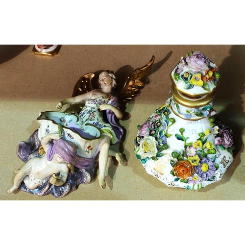 529 - A Dresden style wall pocket encrusted with cherubs; a Dresden style floral encrusted scent bottle