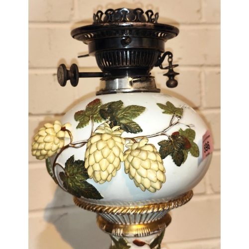 596 - A 19th century ornate table lamp by Moore's, encrusted with flowers and leaves, the column supported... 