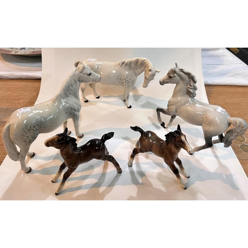 496D - A Beswick 'Connemara' dappled pony and 2 similar ponies; 2 brown Beswick style foals