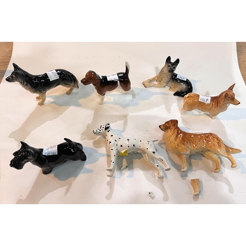 496F - Eight Beswick dogs - Corgi, Scottie, Alsatian x 2, Beagle, Black Labrador, Dalmatian (a.f.), Setter ... 