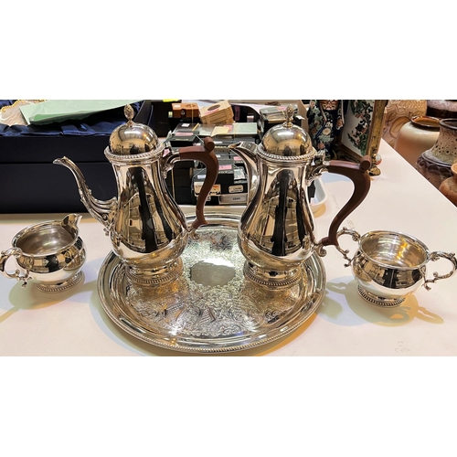 718 - A silver plated 4 piece coffee service by Barker Ellis, with gadrooned border and matched serving tr... 