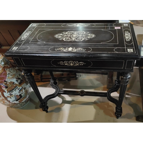 1038 - A 19th century ebonised wood fold over card table with extensive scrolled and floral bone inlay bais... 