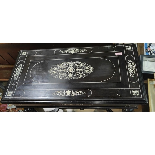 1038 - A 19th century ebonised wood fold over card table with extensive scrolled and floral bone inlay bais... 