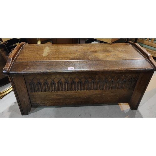 1043 - A carved oak plank style bedding chest with hinged lid