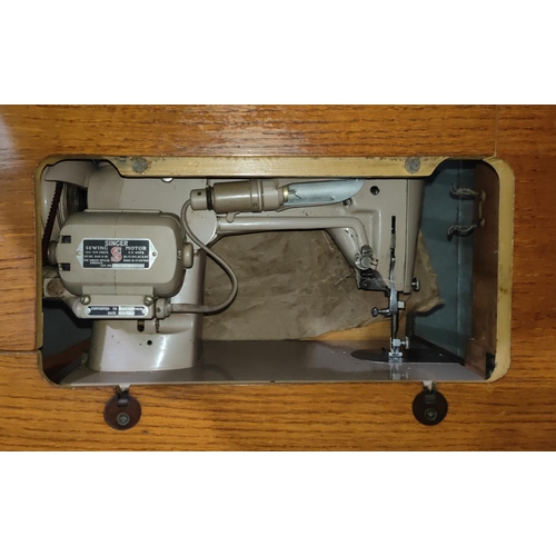 1048 - A light oak sewing table with singer machine to the interior