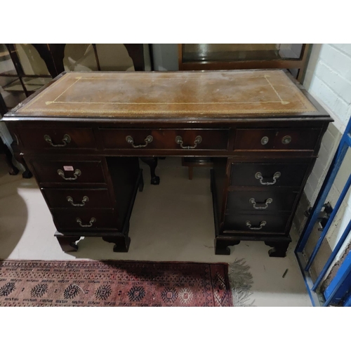 1061 - A mahogany desk with green writing insert, three drawers to each pillar and a central draw