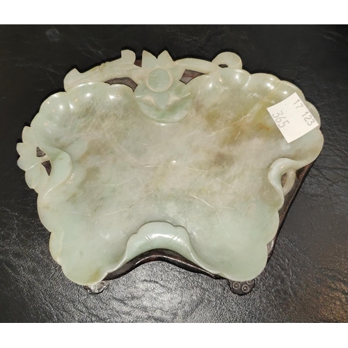 365 - A Chinese jade elephant on hardwood stand, length 10cm; a jade leaf shaped bowl on hardwood stand, l... 