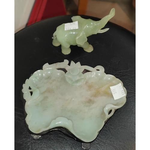 365 - A Chinese jade elephant on hardwood stand, length 10cm; a jade leaf shaped bowl on hardwood stand, l... 