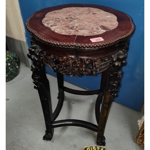 458 - A Chinese hardwood stand with lotus shaped marble top, carved decoration with pierced rim and dragon... 