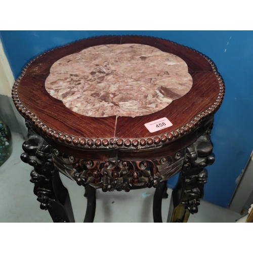 458 - A Chinese hardwood stand with lotus shaped marble top, carved decoration with pierced rim and dragon... 