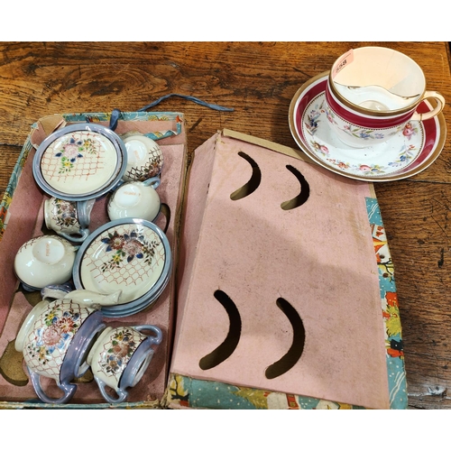 558 - A 19t century English porcelain moustache cup and saucer with pink and gilt floral decoration and a ... 