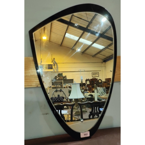 968 - A mid 20th century shaped mirror in black/clear glass