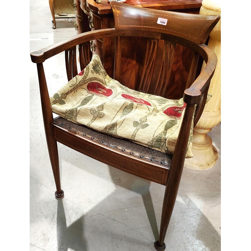 1004 - An Edwardian Art Nouveau armchair in inlaid mahogany, with squat cushion