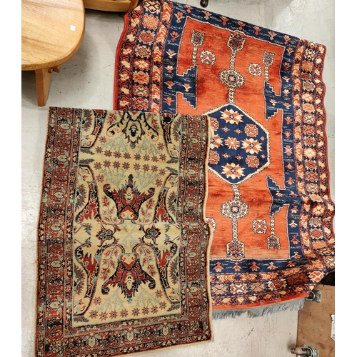 1012 - A Persian design rug with blue ground; a similar fawn runner