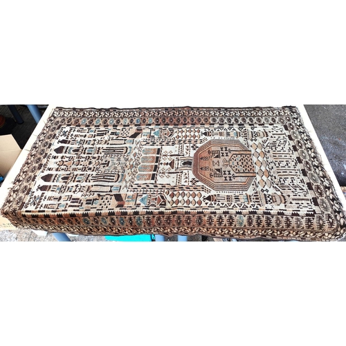 939 - A brown and cream ground middle eastern rug decorated with buildings etc, possibly cut down 150x95cm... 