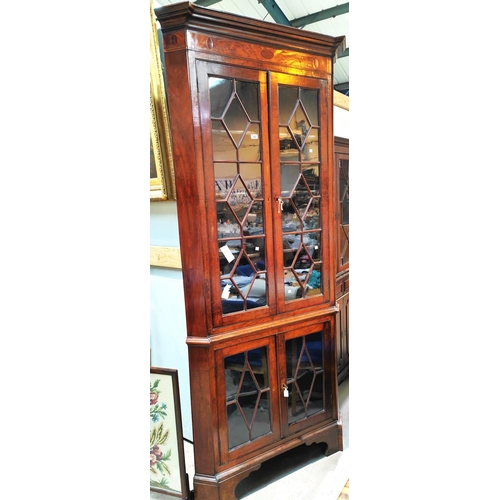 950 - A Georgian mahogany floor standing corner cabinet with moulded cornice and inlaid frieze, enclosed b... 