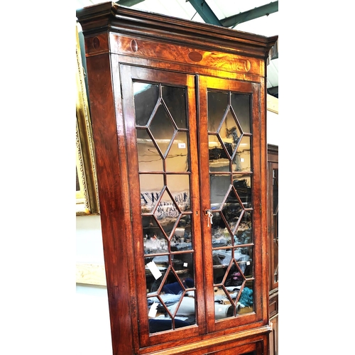 950 - A Georgian mahogany floor standing corner cabinet with moulded cornice and inlaid frieze, enclosed b... 