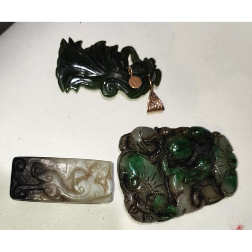 440A - Three Chinese jade coloured hard stone items: One carved belt loop and two pendants, one mounted in ... 