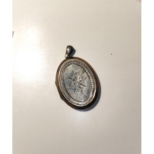 647A - A late 19th century locket with incised decoration to the front and back