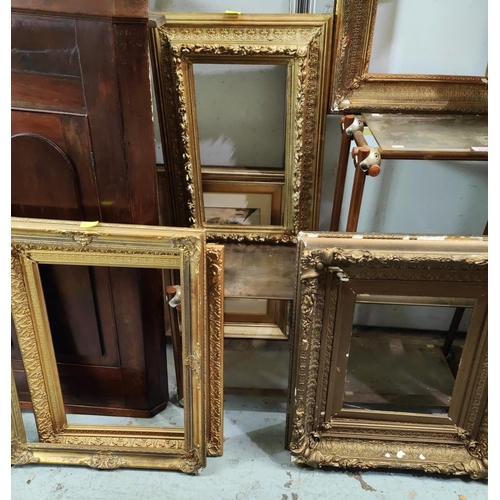 855A - A selection of large antique gilt picture frames with various designs and sized, largest overall 99 ... 