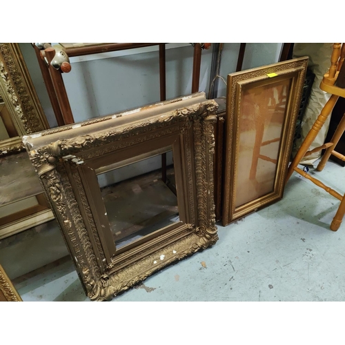 855A - A selection of large antique gilt picture frames with various designs and sized, largest overall 99 ... 