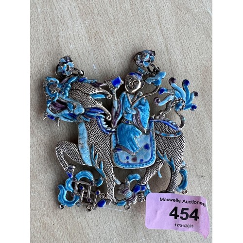 454 - A Chinese white metal dragon pendant with blue enamel decoration to both sides, length 9cm