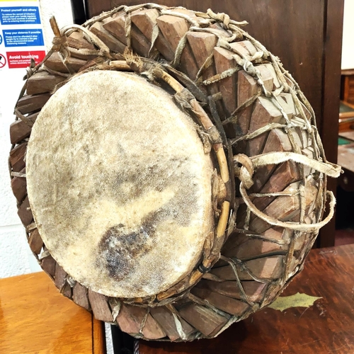 18 - An early to mid 20th century African style tribal drum with interlinking wooden sections, with hide ... 