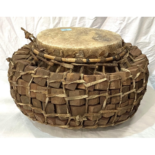 18 - An early to mid 20th century African style tribal drum with interlinking wooden sections, with hide ... 