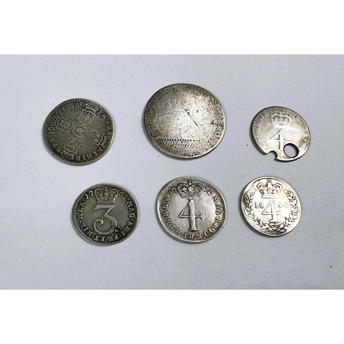 181 - A Queen Anne 1/- and a 1697 6d; four various Maundy coins (2 holed)