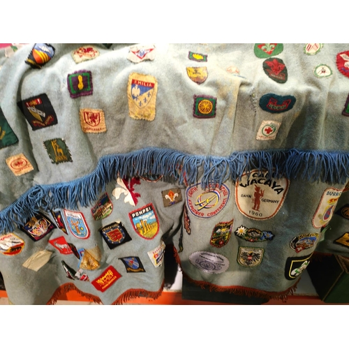 22 - A selection of circa 1950's European and world scout badges on a fireside possibly collected for Jam... 