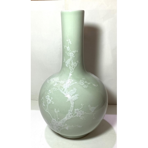 414 - A Chinese celadon bottle vase decorated in white with birds on branches etc seal mark to base, heigh... 