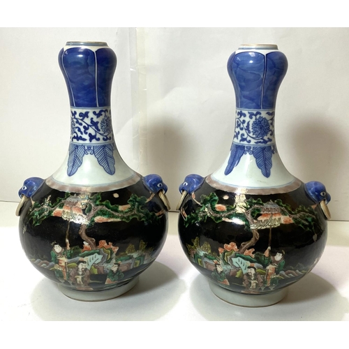 415 - A pair of Chinese Famille Noir vases with blue and white highlights, traditional scenes with 6 chara... 